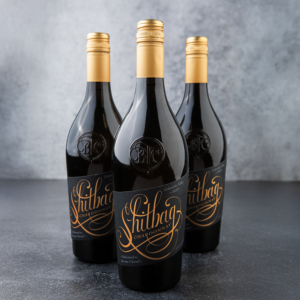 Three bottles of Shitbag Chardonnay